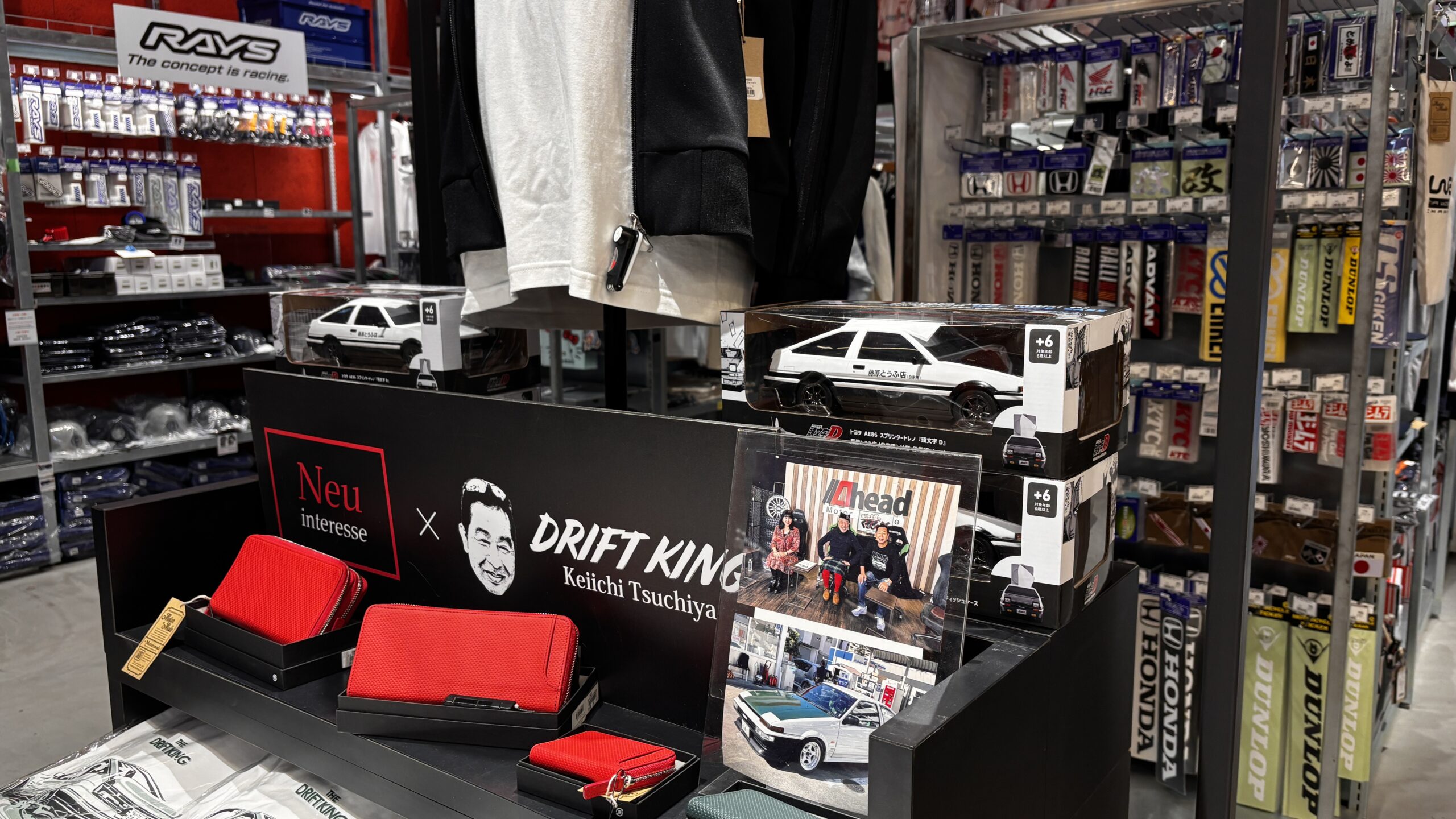 A PIT Shinonome Tokyo display featuring JDM icons and Japanese car culture items