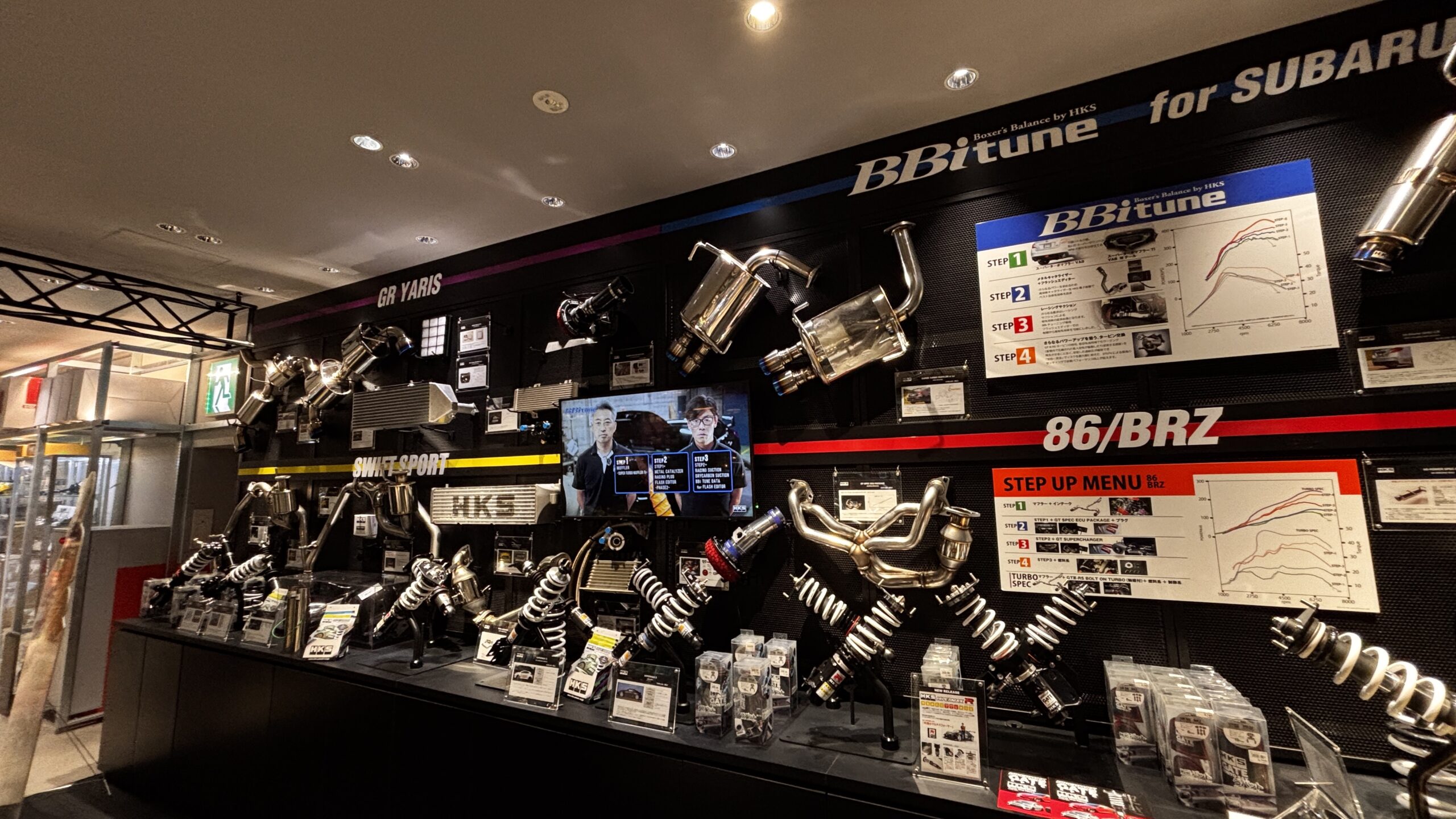 JDM performance parts and titanium exhaust display at A PIT Shinonome Tokyo