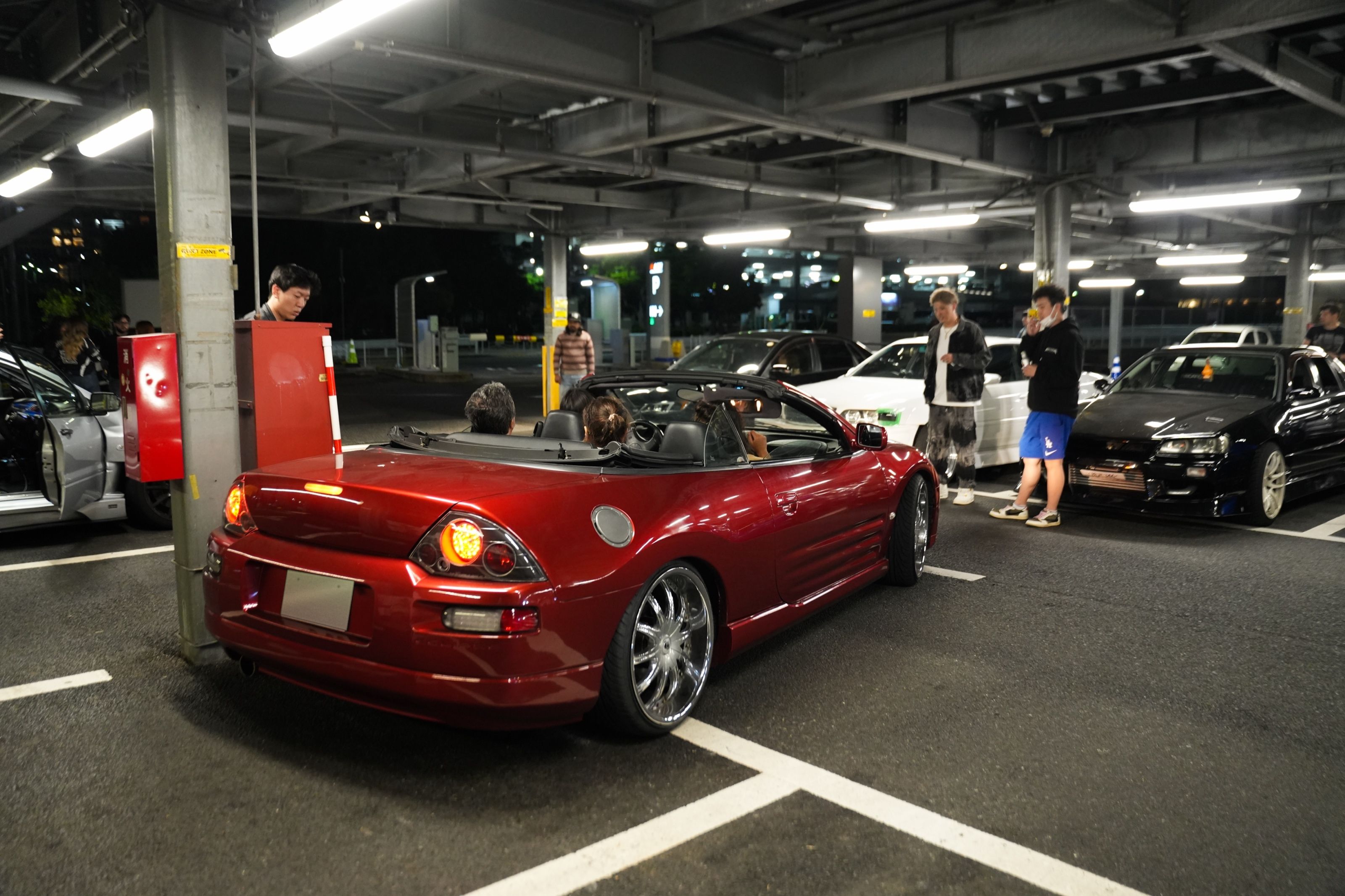 Candy red Mitsubishi Eclipse Spyder convertible at night